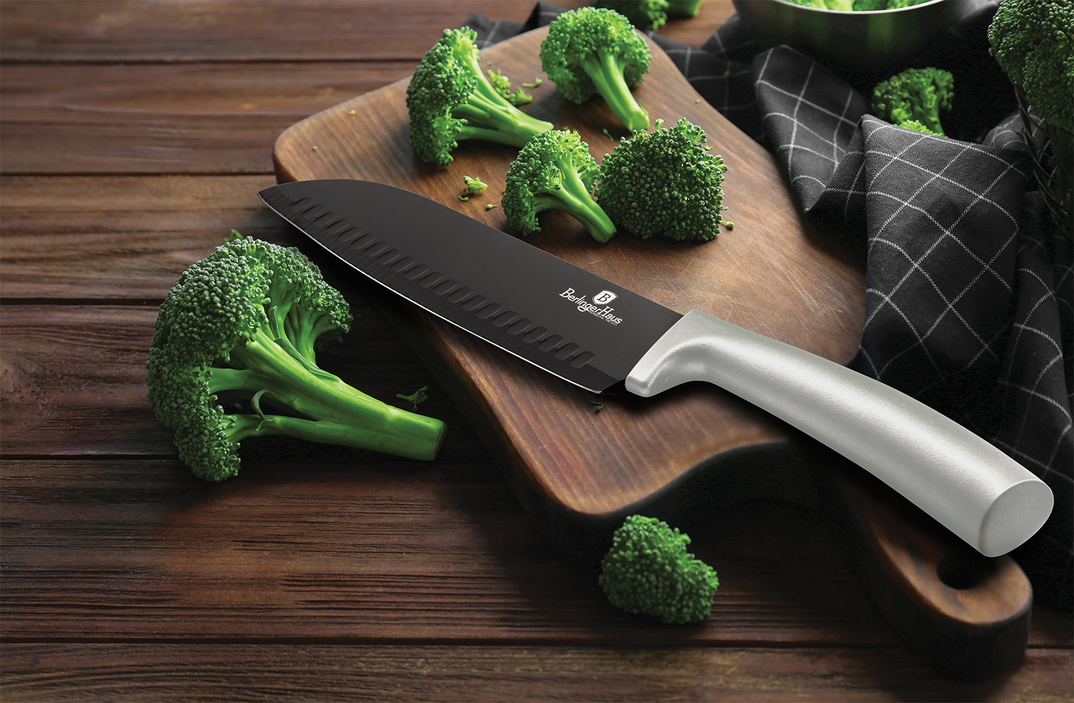 Fresh green broccoli and knife on wooden board