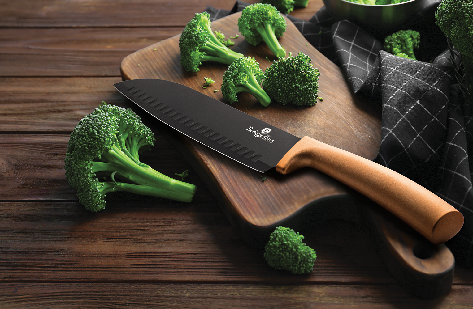Fresh green broccoli and knife on wooden board