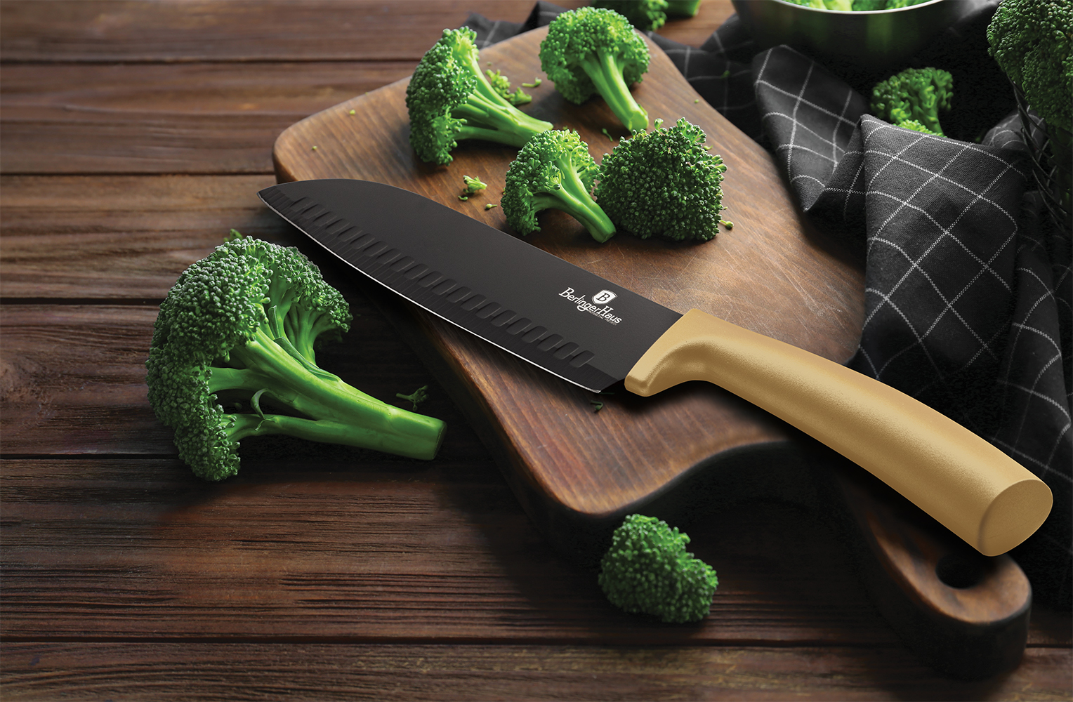 Fresh green broccoli and knife on wooden board