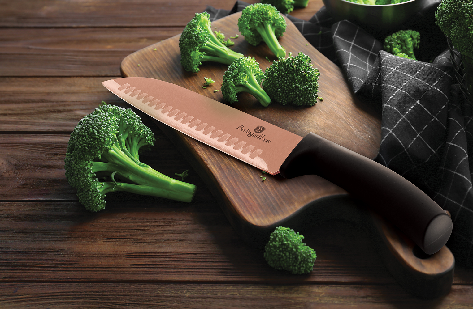 Fresh green broccoli and knife on wooden board