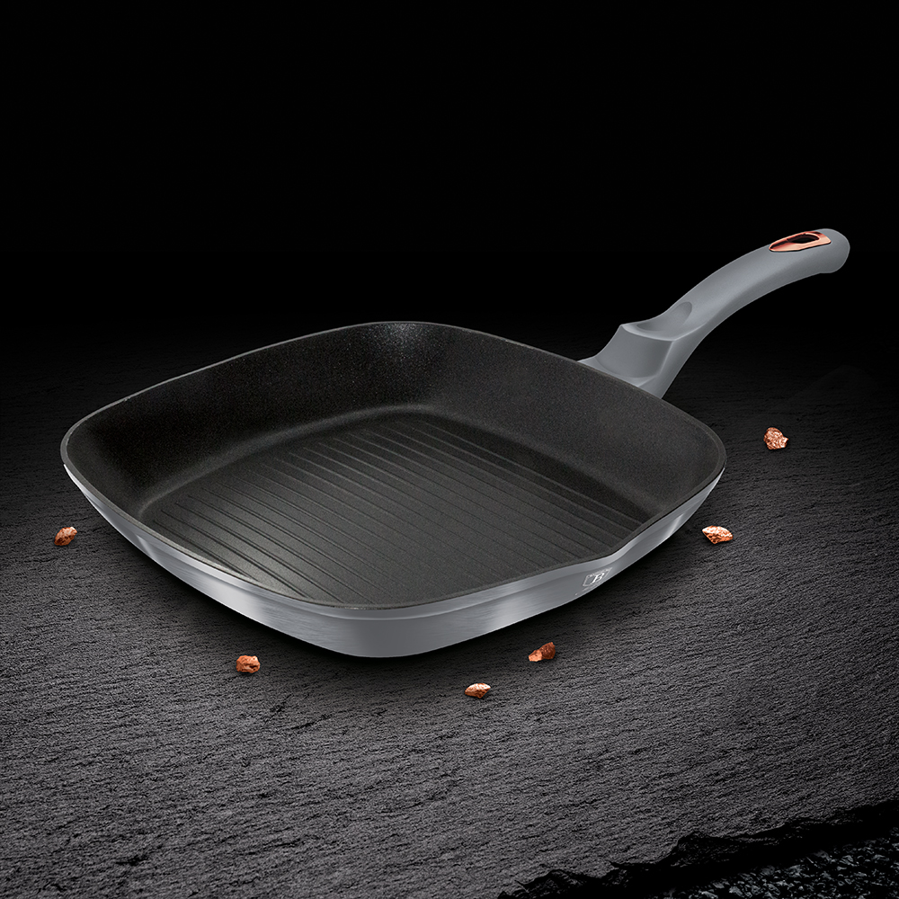 Partially Covered Copper Cooking Pot Between Garlic And Carving